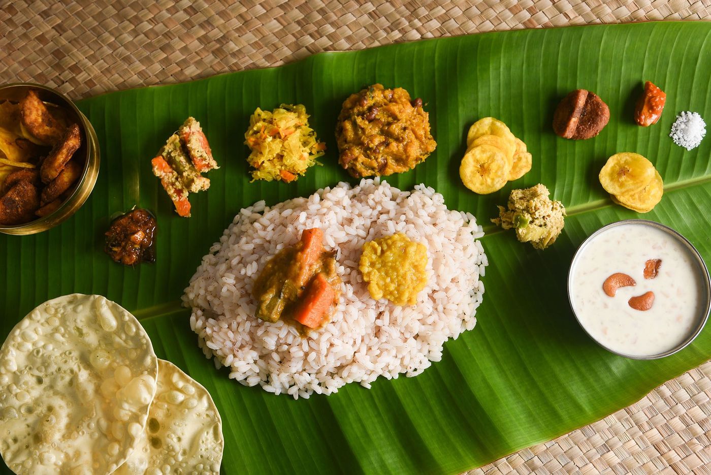 Kerala food for Onam festival special curry for Onam sadya or sadhya in green banana leaf background. Also popular Sri Lankan food . South Indian vegetarian vegan food lunch
